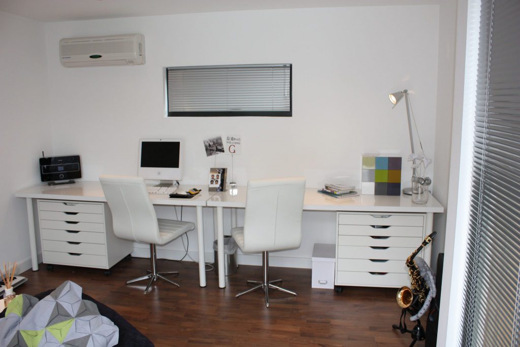 Interior of garden office with desk and air conditioning unit